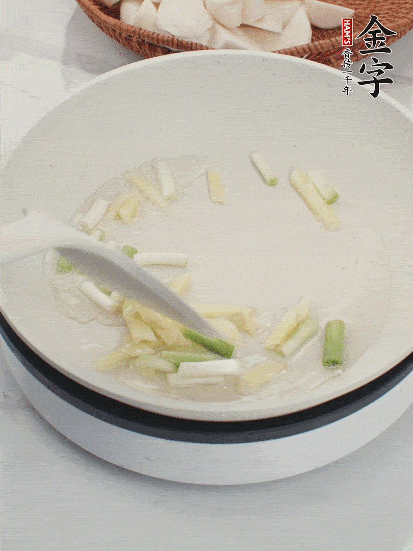 鍋中油五成熱，下蔥白、姜片爆香。