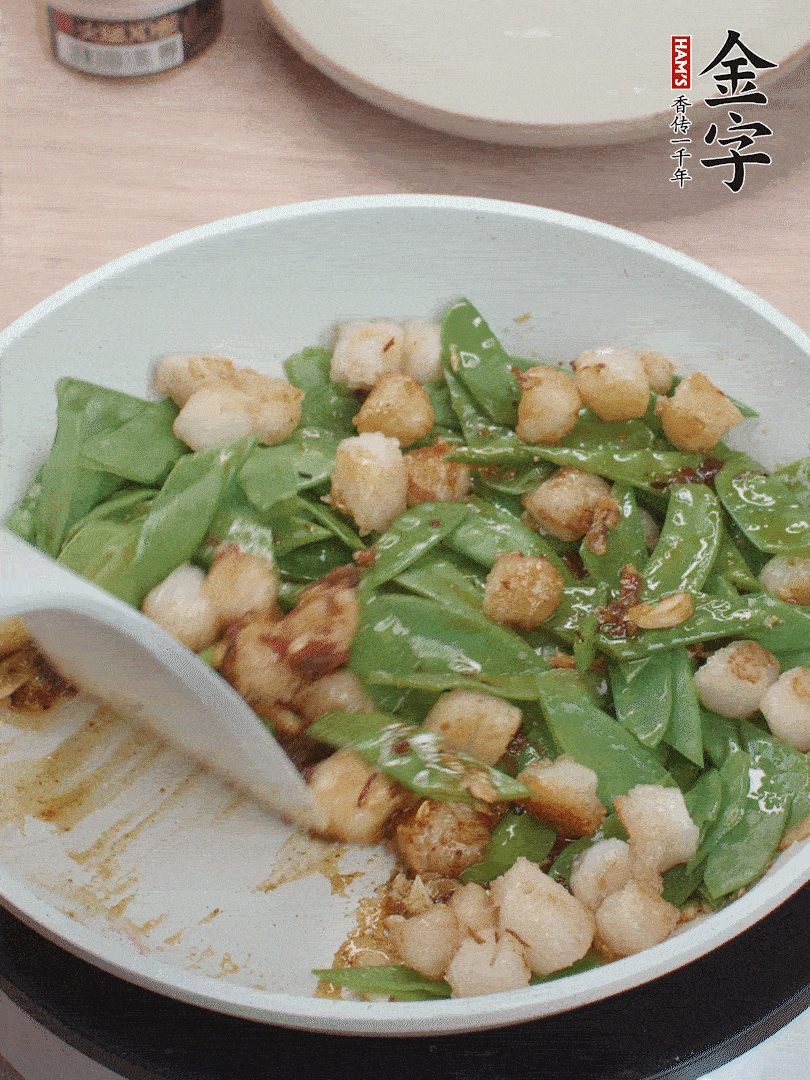 下甜豆莢、鮮貝輕輕翻炒均勻。